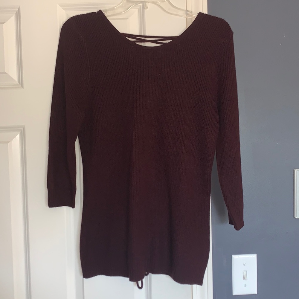 This is a dark purple shirt. It’s size small. The sleeves are a tad short.